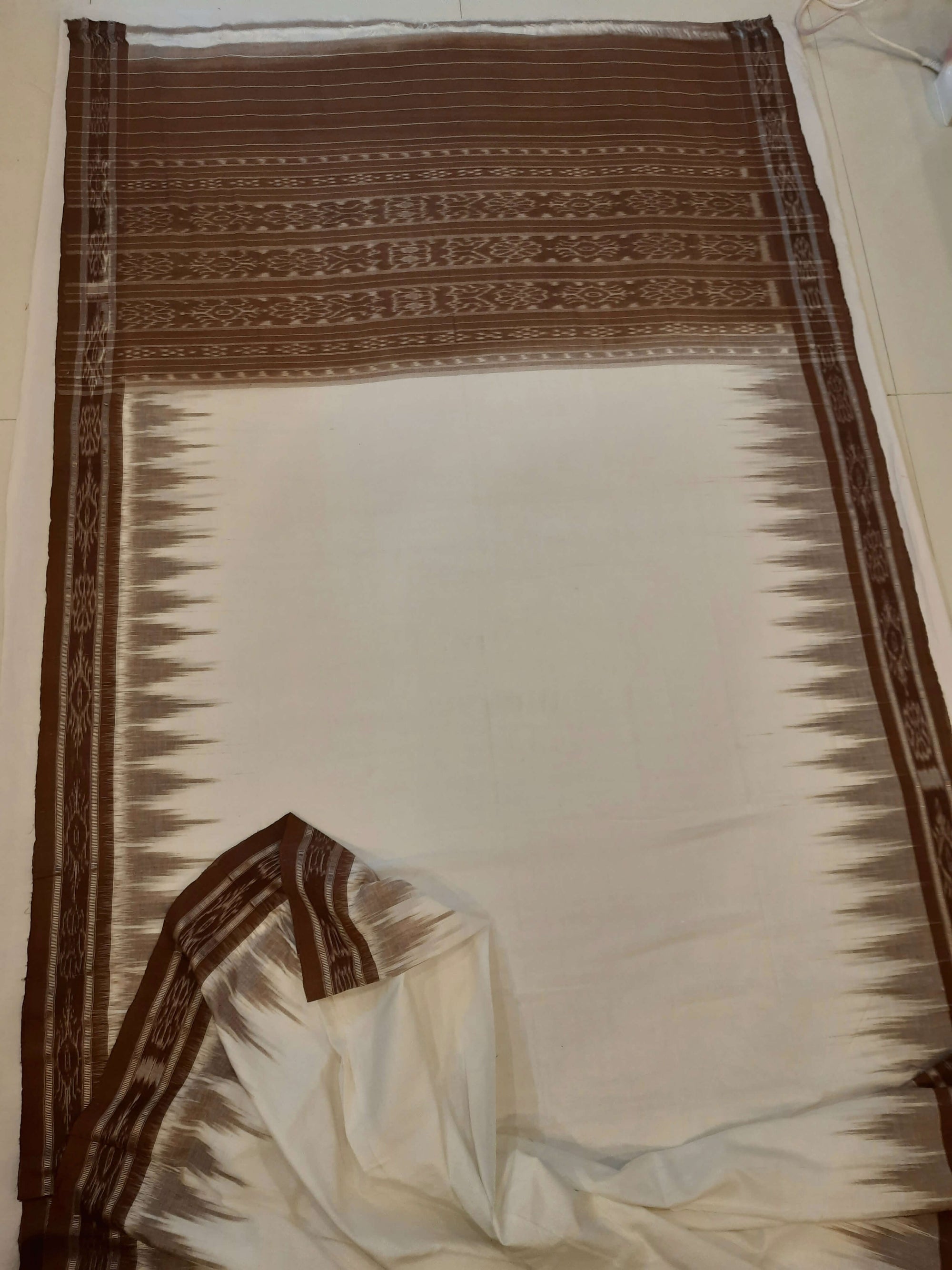 White and Brown coloured Odisha Ikat saree  with cotton ikat blouse piece