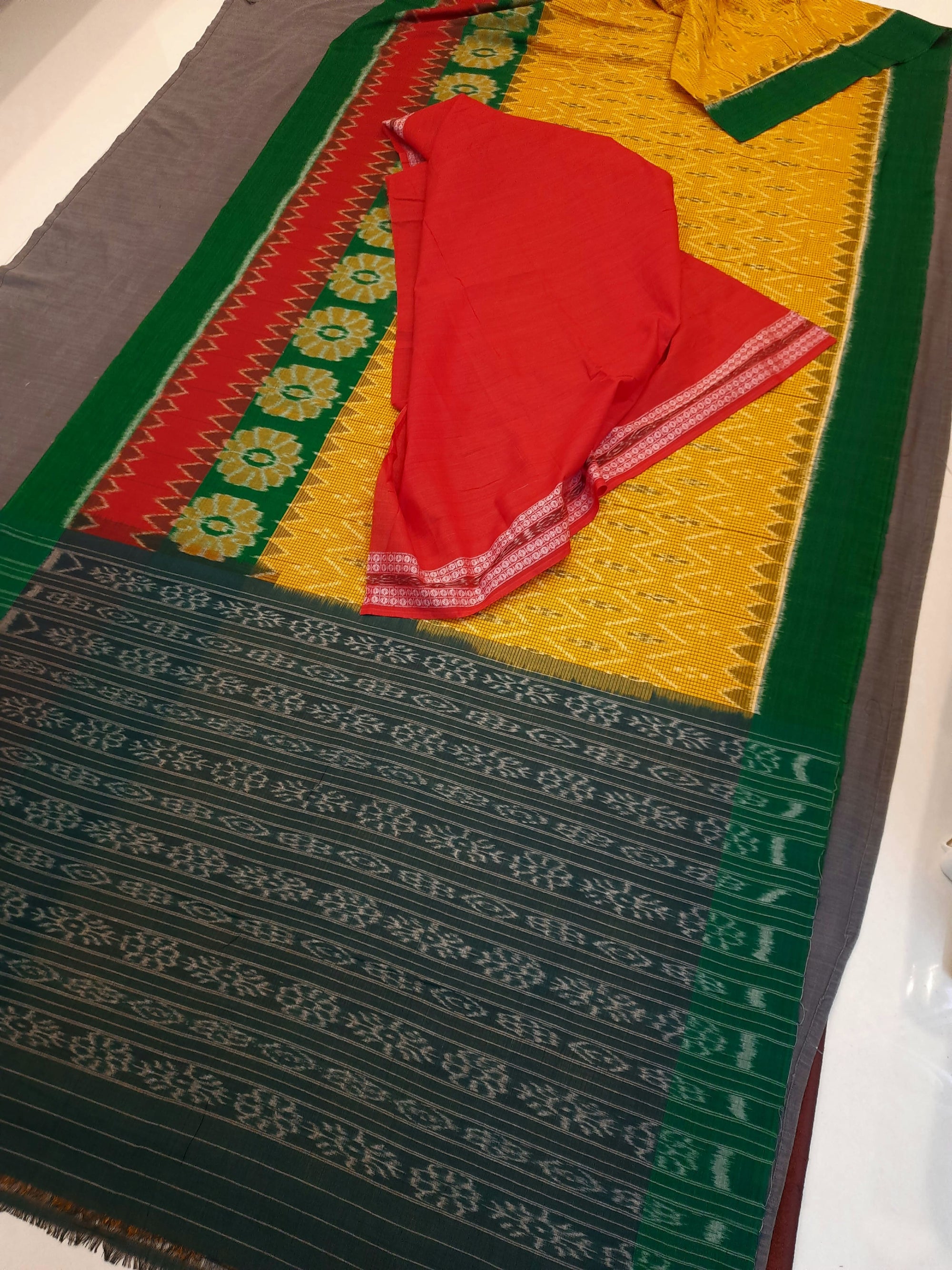 Yellow Green Odisha Ikat saree with wide border paired with cotton ikat blouse piece