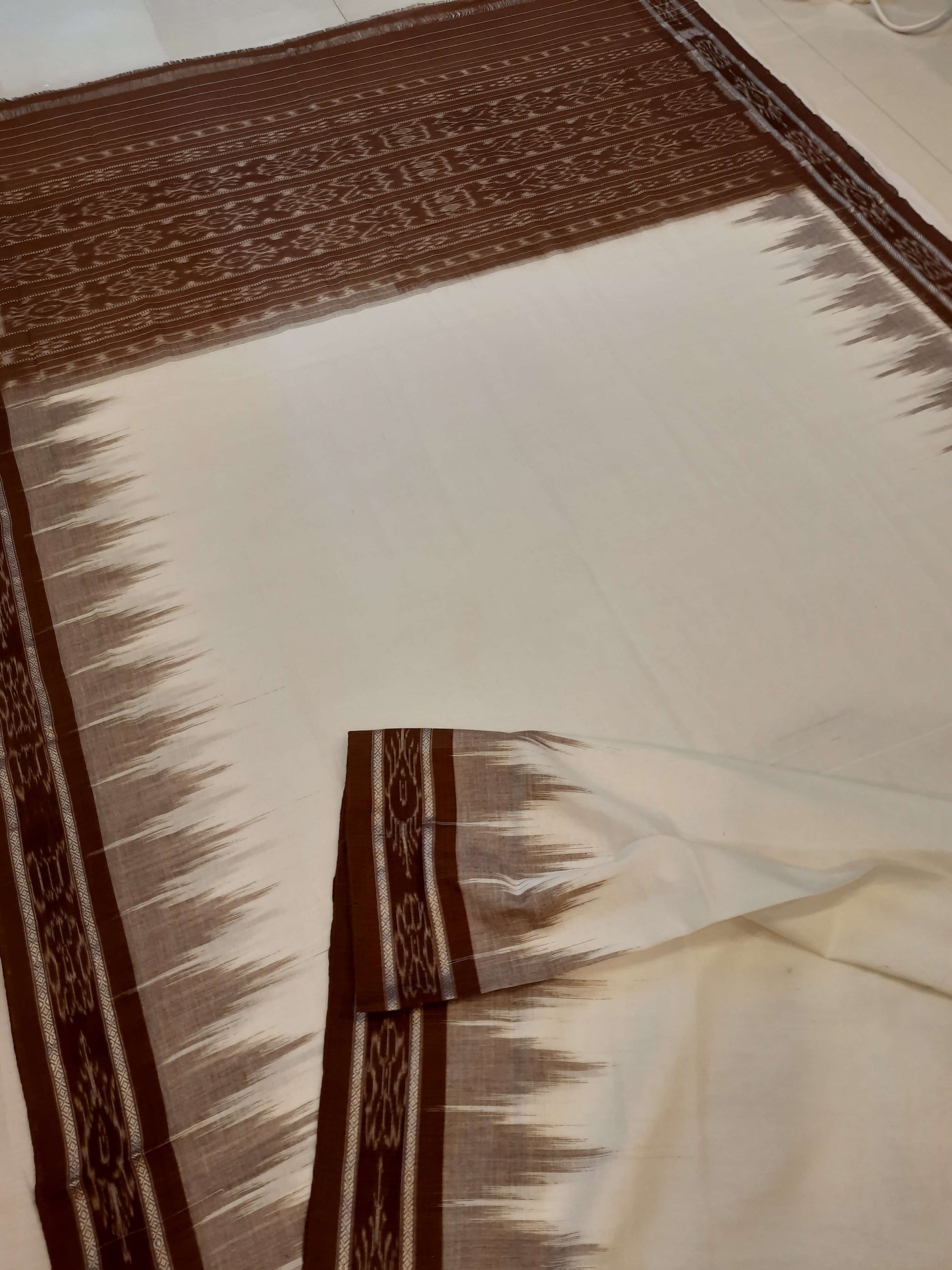 White and Brown coloured Odisha Ikat saree  with cotton ikat blouse piece
