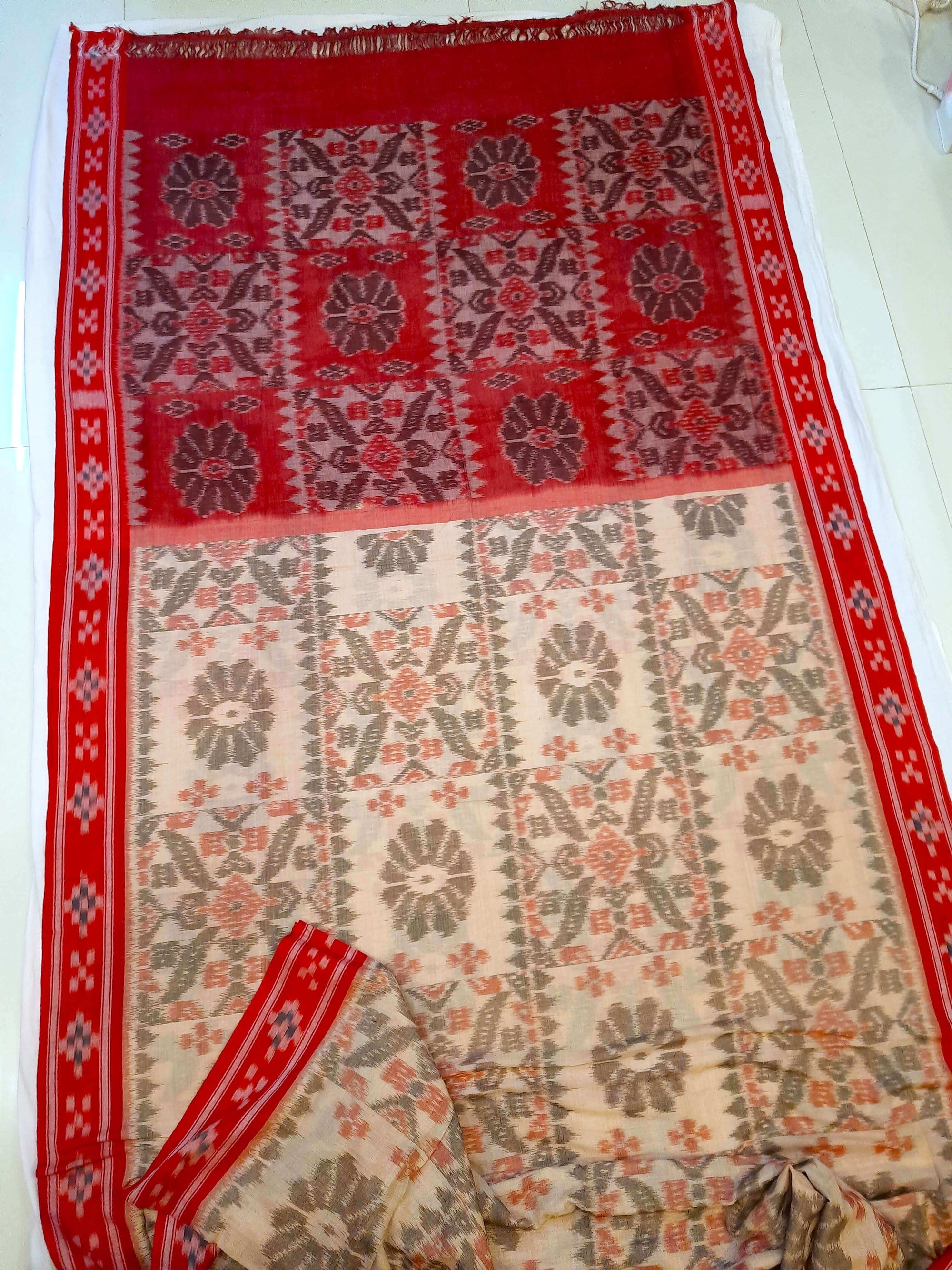 Beige and Red coloured Odisha Ikat saree  with cotton ikat blouse piece