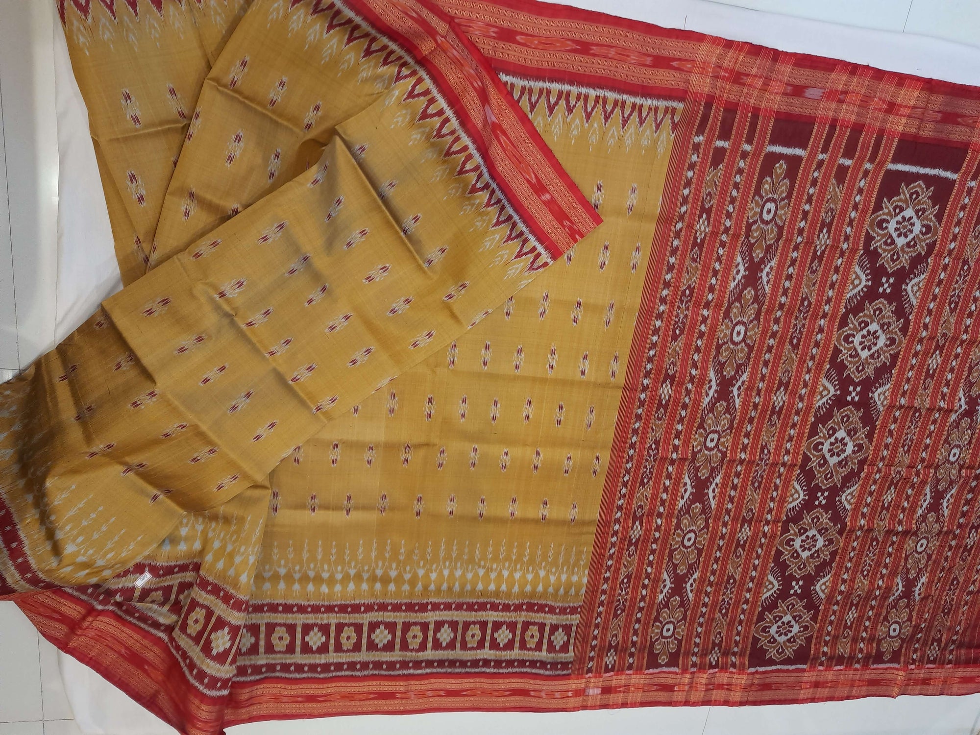 Golden wide border Odisha Khandua Pata Silk Saree paired with cotton ikat blouse piece