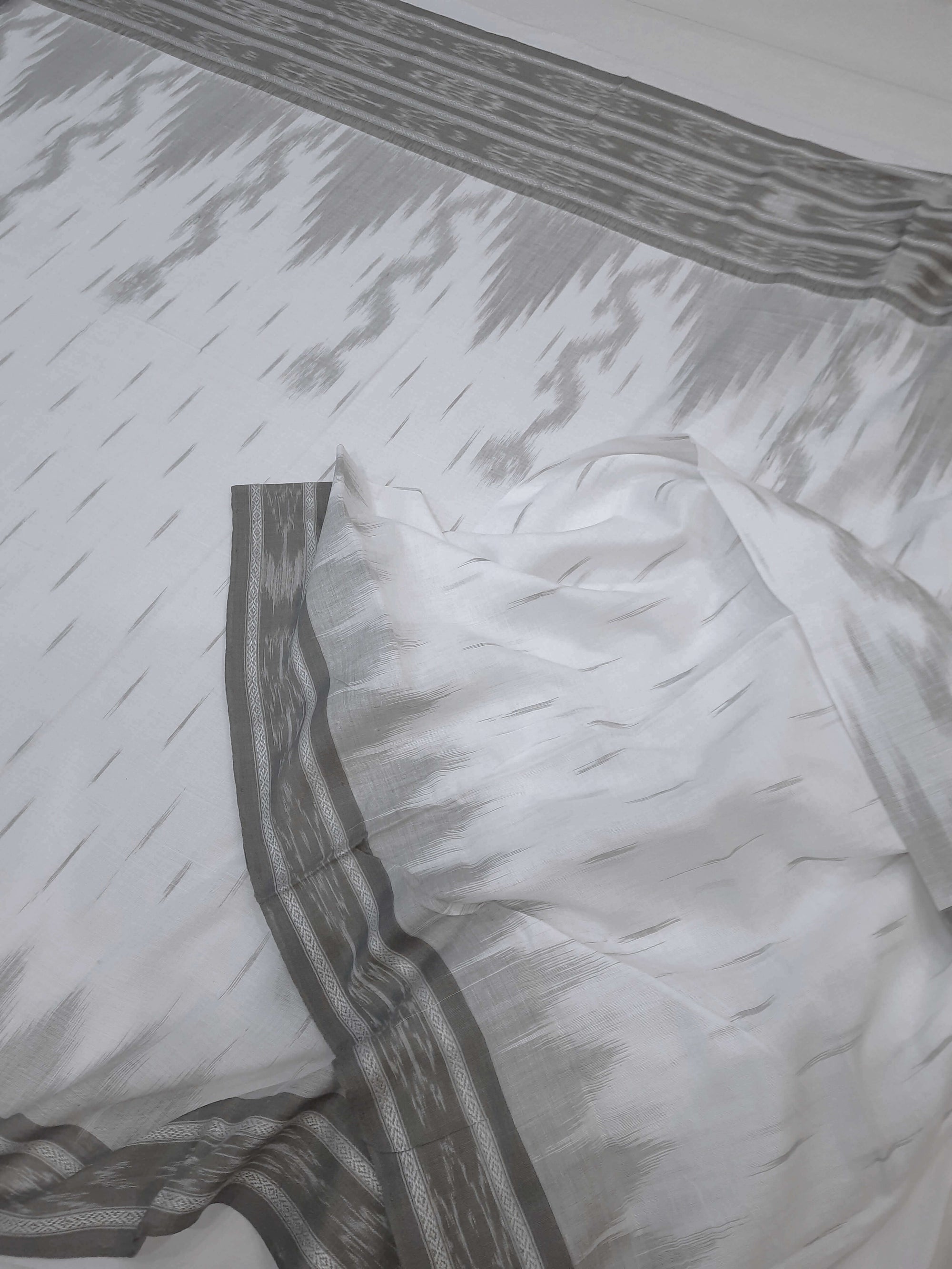 White wide border Cotton Odisha Ikat saree with mix match cotton ikat blouse