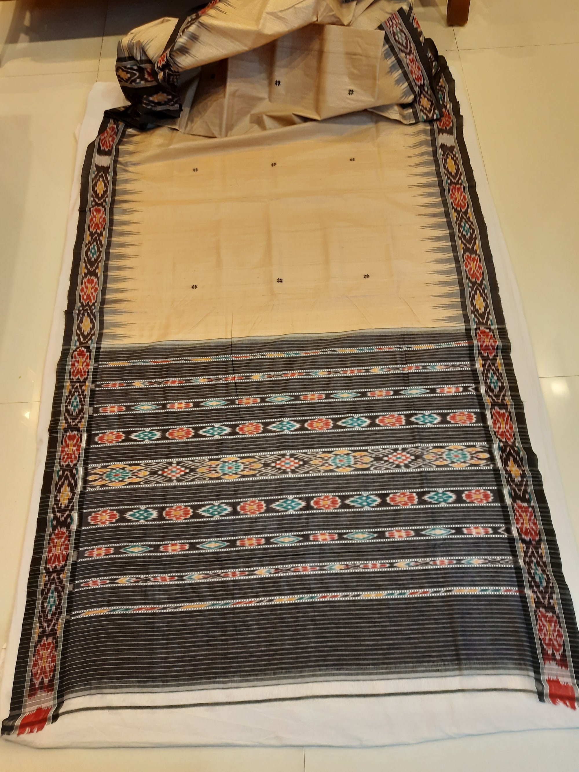 Beige with Black Tussar Silk Odisha Ikat Saree paired with cotton ikat blouse piece