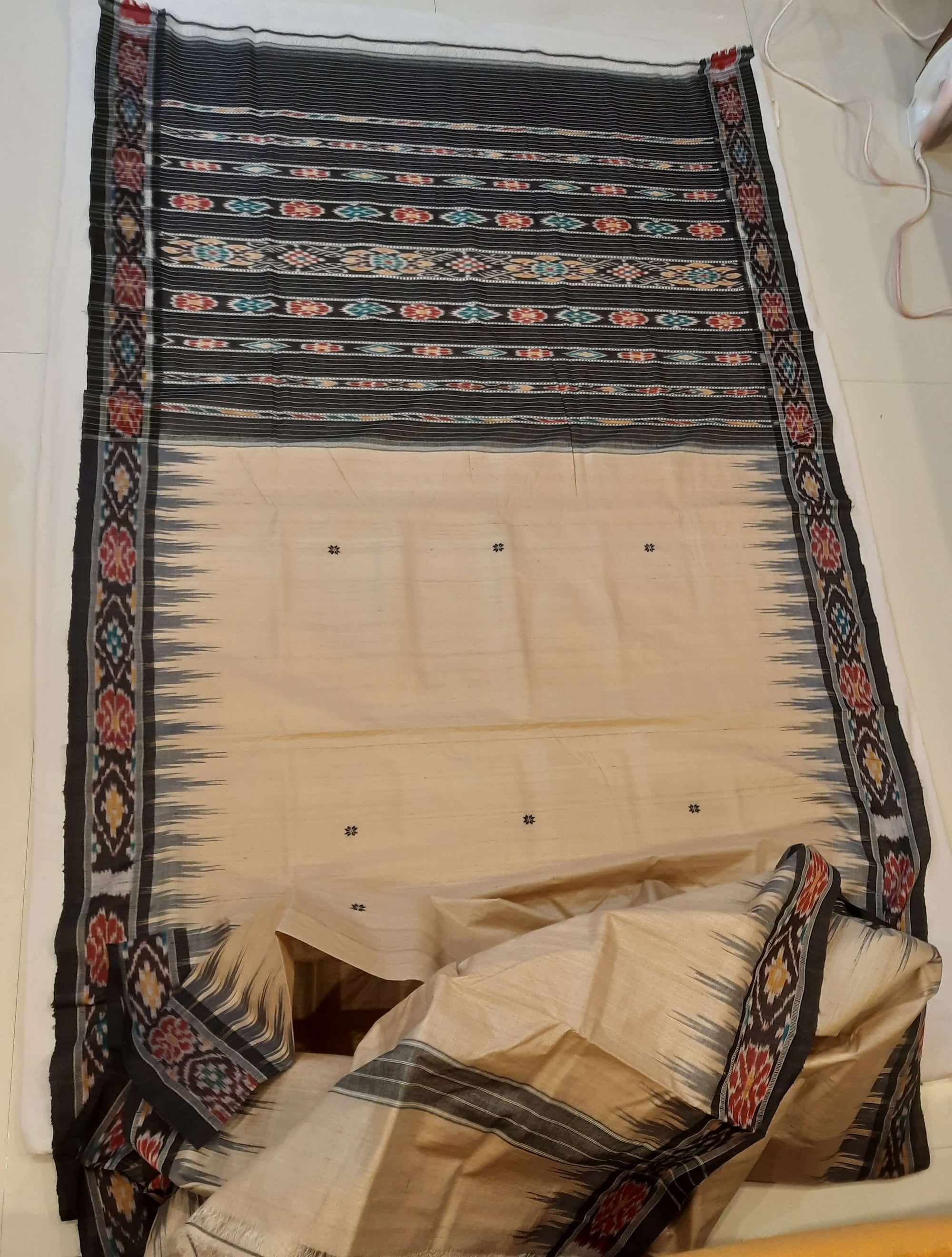 Beige with Black Tussar Silk Odisha Ikat Saree paired with cotton ikat blouse piece