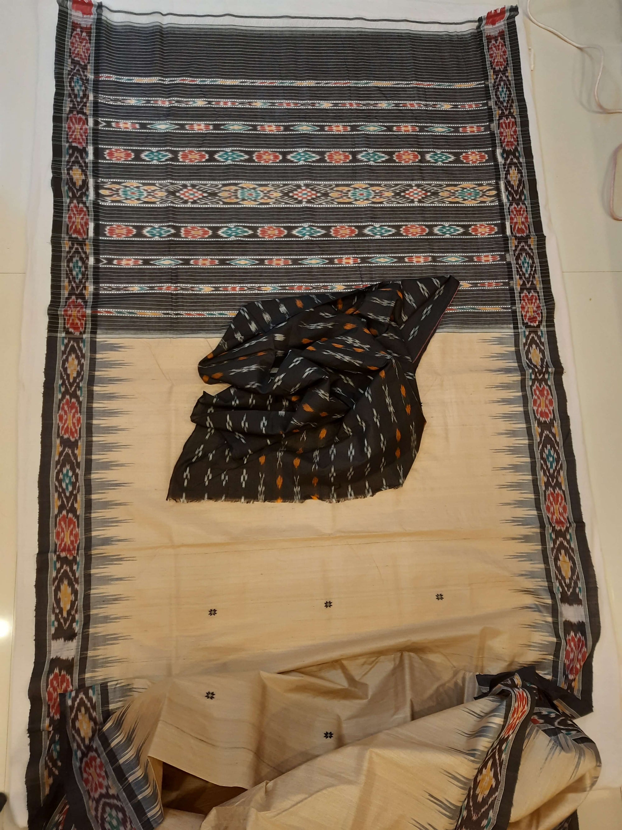 Beige with Black Tussar Silk Odisha Ikat Saree paired with cotton ikat blouse piece